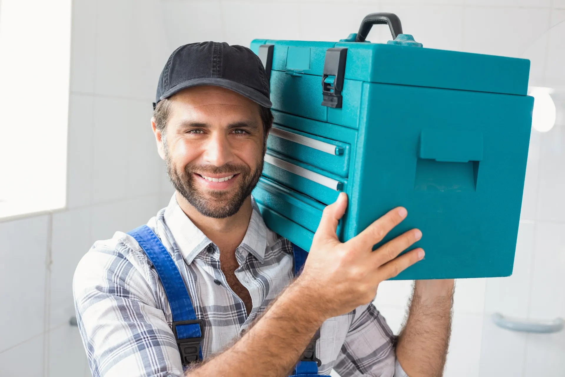 Local plumber in Blackburn carrying his toolbox after a job